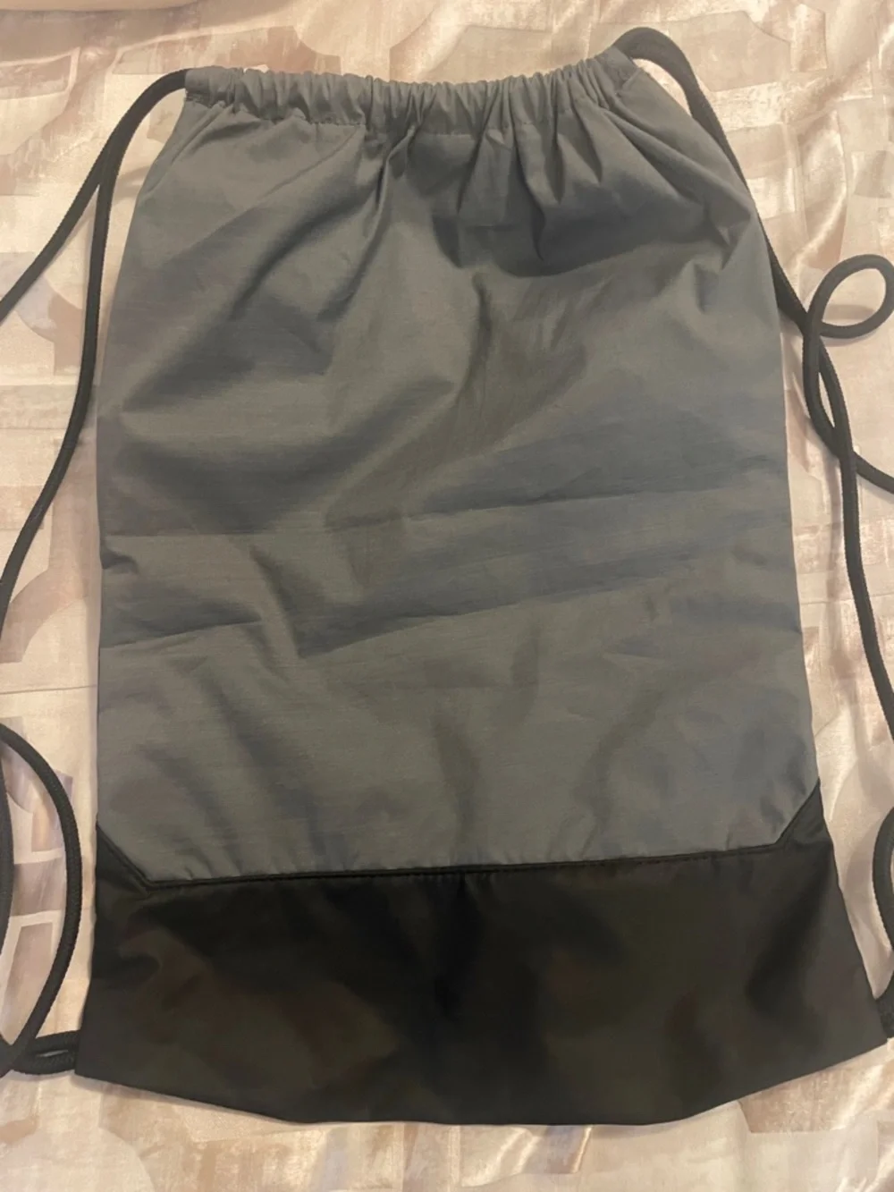 Nike Gray and Black Drawstring Backpack with White Swoosh